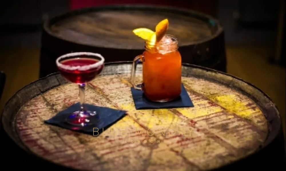 a couple of drinks on barrel in a speakeasy bar