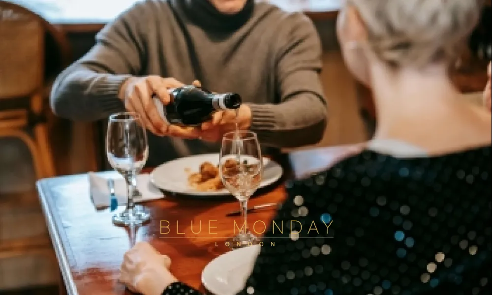 a man pouring wine into a glass on a date with a woman