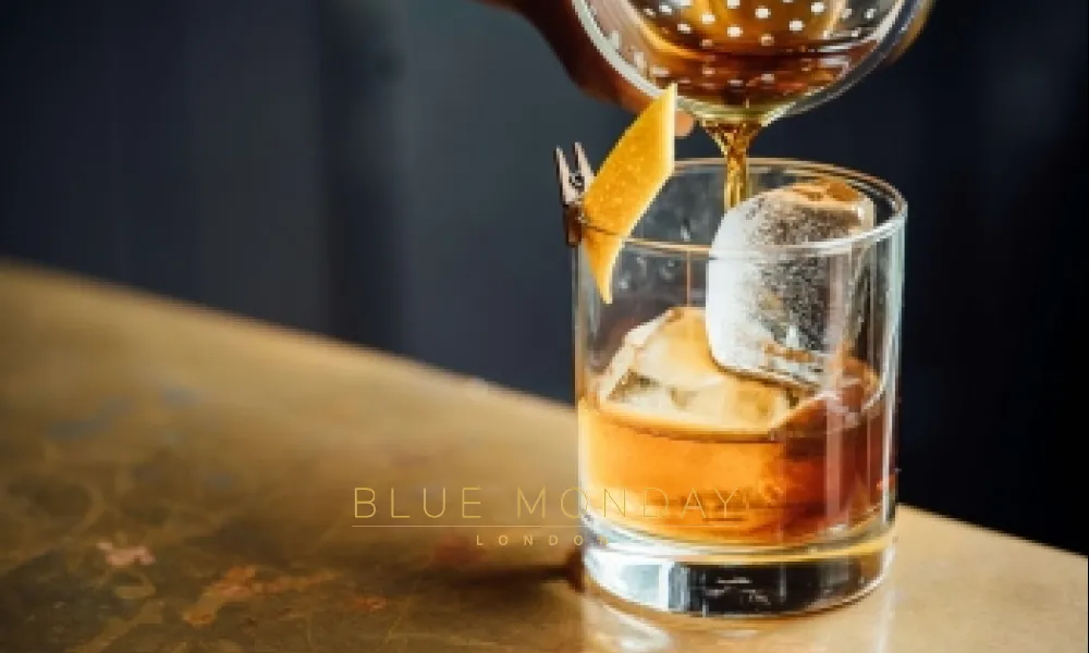 a drink being poured on a bar