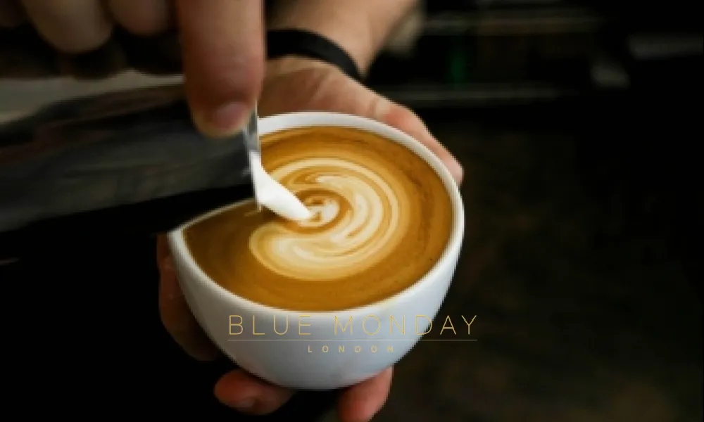 milk being poured into a coffee cup in a coffee shop
