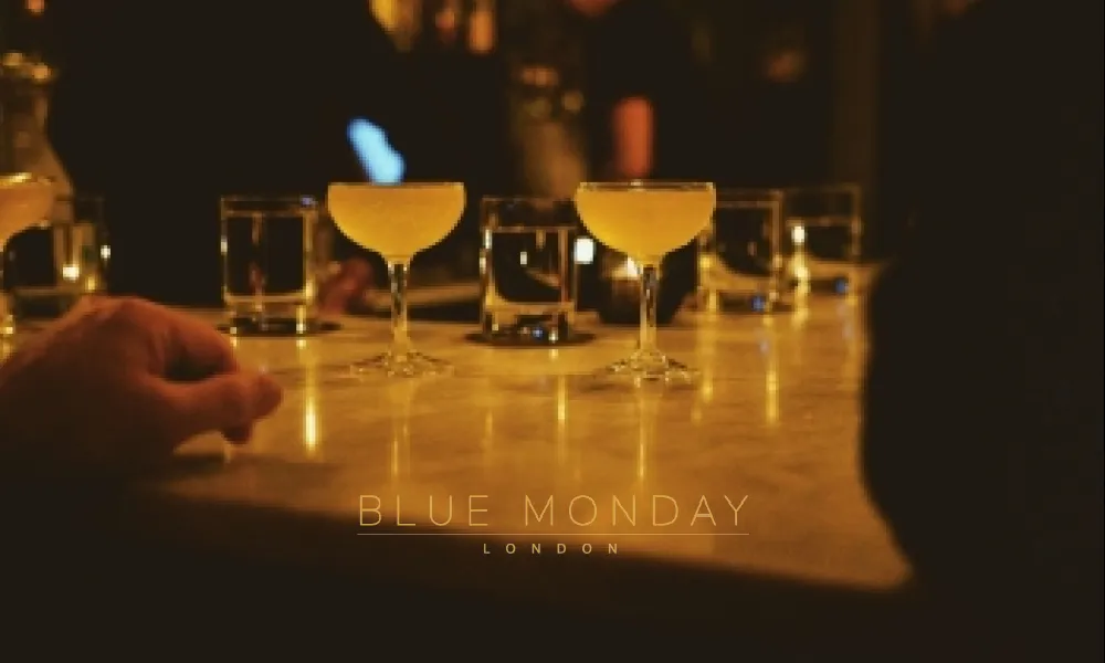 cocktails and glasses on a table in a bar
