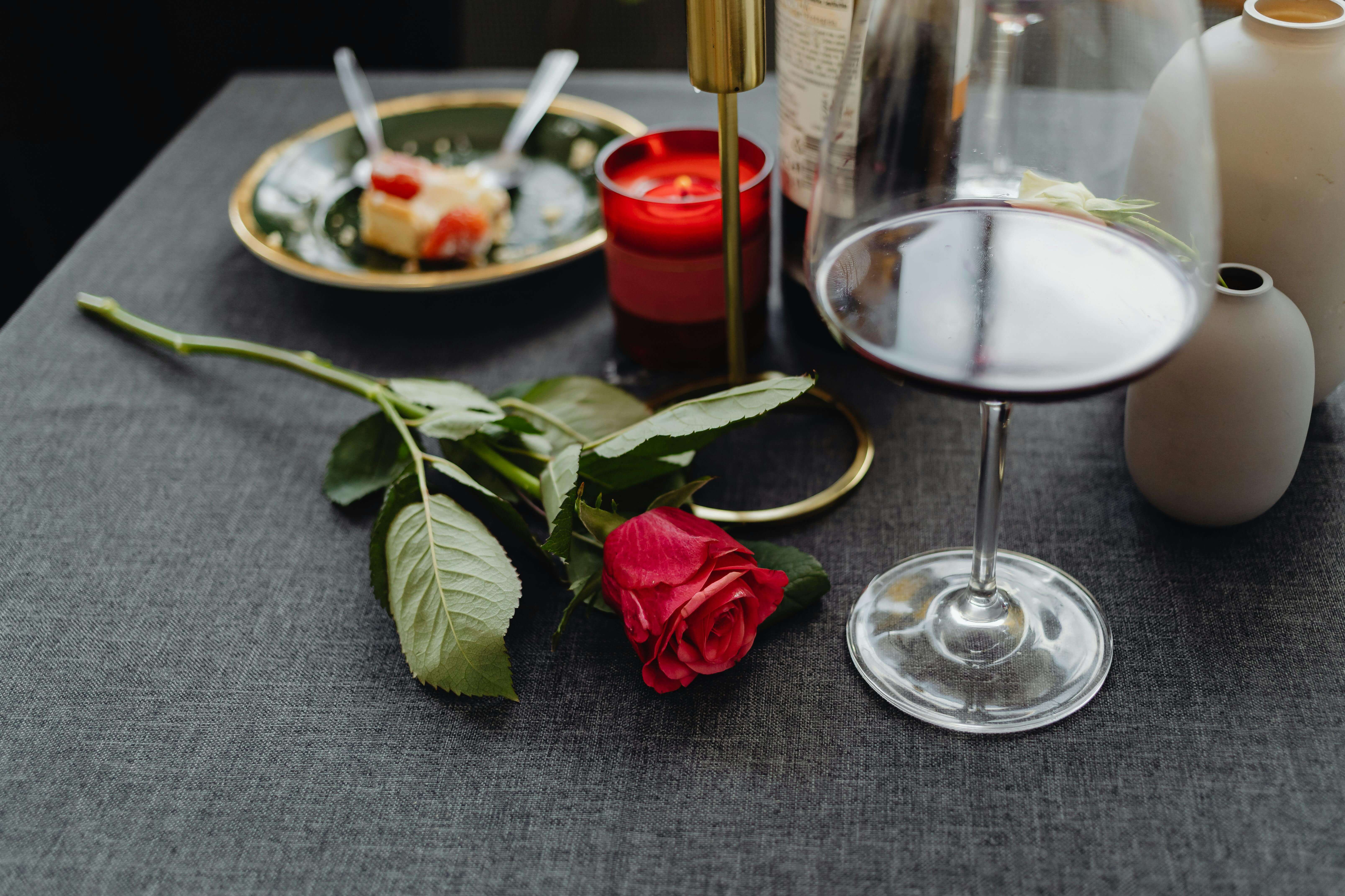a red rose on a restaurant dinner table