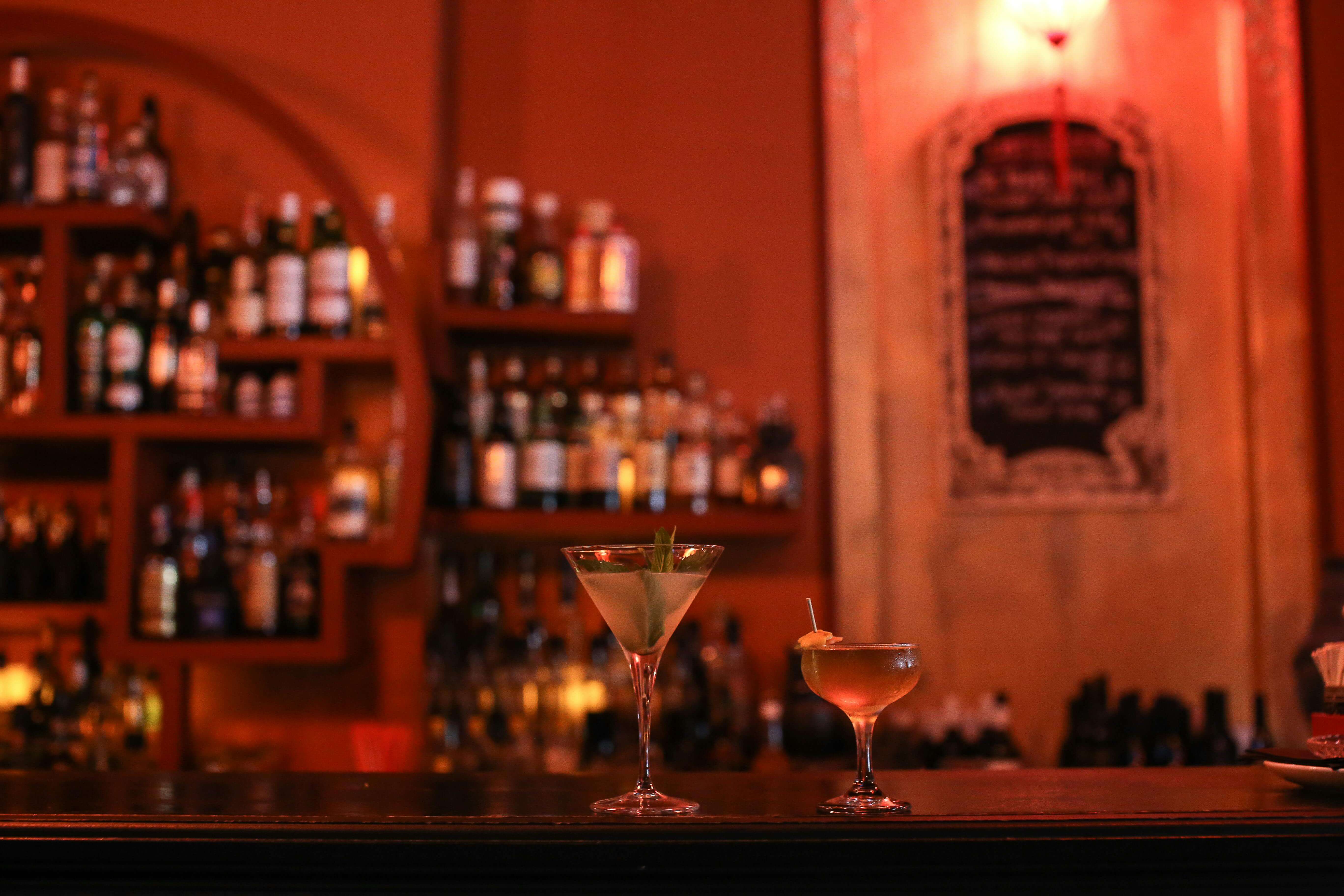 two cocktails on a bar