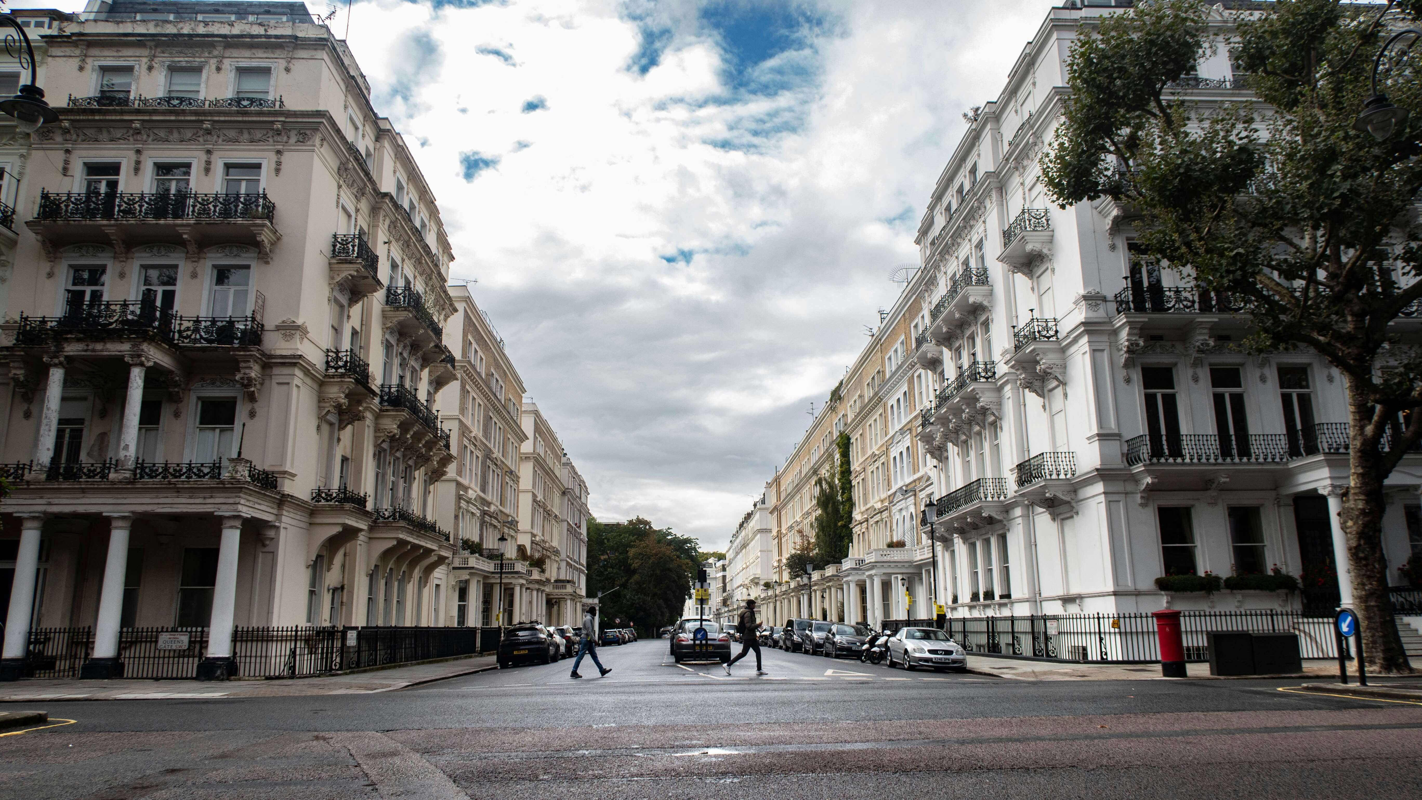 people walking across a street in Chelsea, London