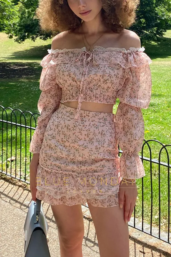 Valentina in a pink floral outfit. Long sleeved crop top and high waisted short skirt.